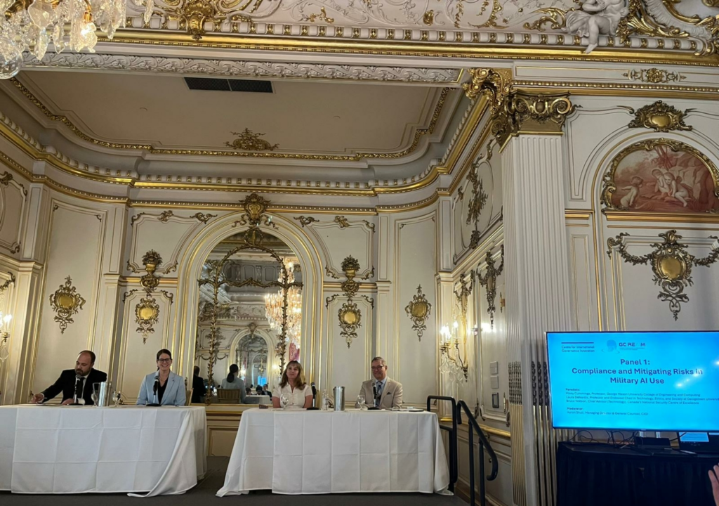 Laura DeNardis seated at a table at the Cosmos Club, along with other panelists